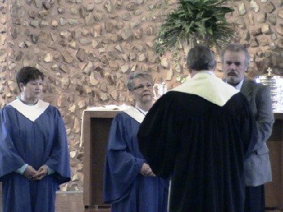 Pastor Lamm charges Karen, Pam and Twig to service on Session. 